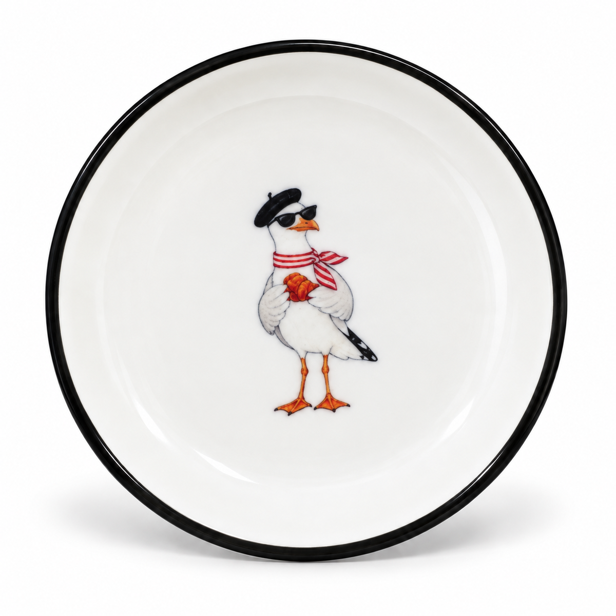 A little Parisian twist on the West Coast. This 4-inch ceramic trinket tray features our stylish seagull in a beret and sunglasses, holding a fresh croissant. Finished with a classic black rim, it’s perfect for rings, earrings, or the little treasures you want to keep close.

A playful piece for anyone who loves the coast, Paris, and a touch of Sunday café style.